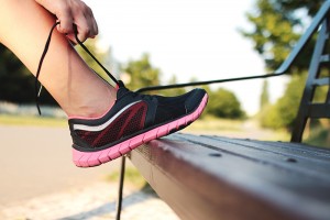 lacing up some running shoes to stay active and healthy